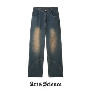 Front flat lay view of deep indigo vintage wash denim trousers featuring unique diagonal panel stitching and tan-toned fading.