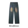 Rear view of vintage wash denim trousers, showcasing back pocket design, waistband labels, and paneling details at the lower leg.
