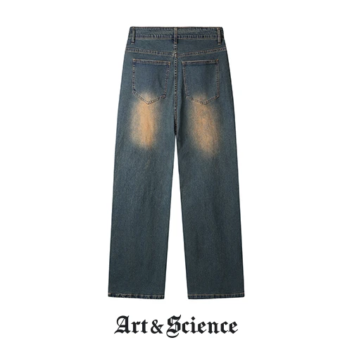 Rear view of vintage wash denim trousers, showcasing back pocket design, waistband labels, and paneling details at the lower leg.